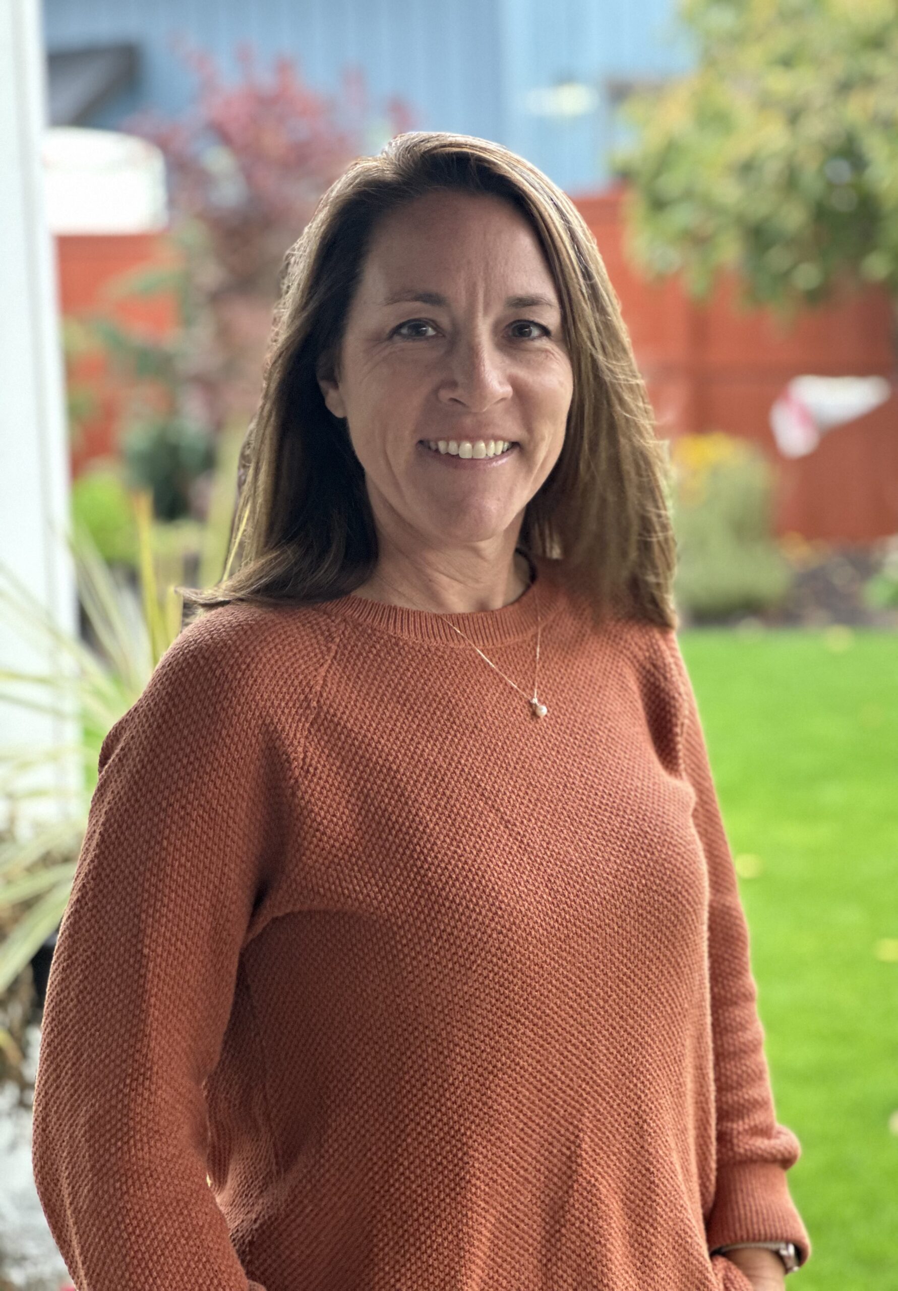 Proud Beaver Baseball mom standing behind a new fence